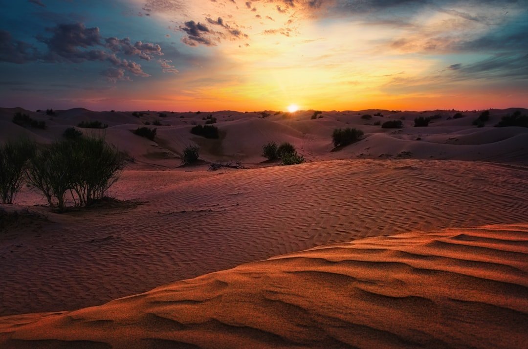 brown sand under cloudy sky during daytime