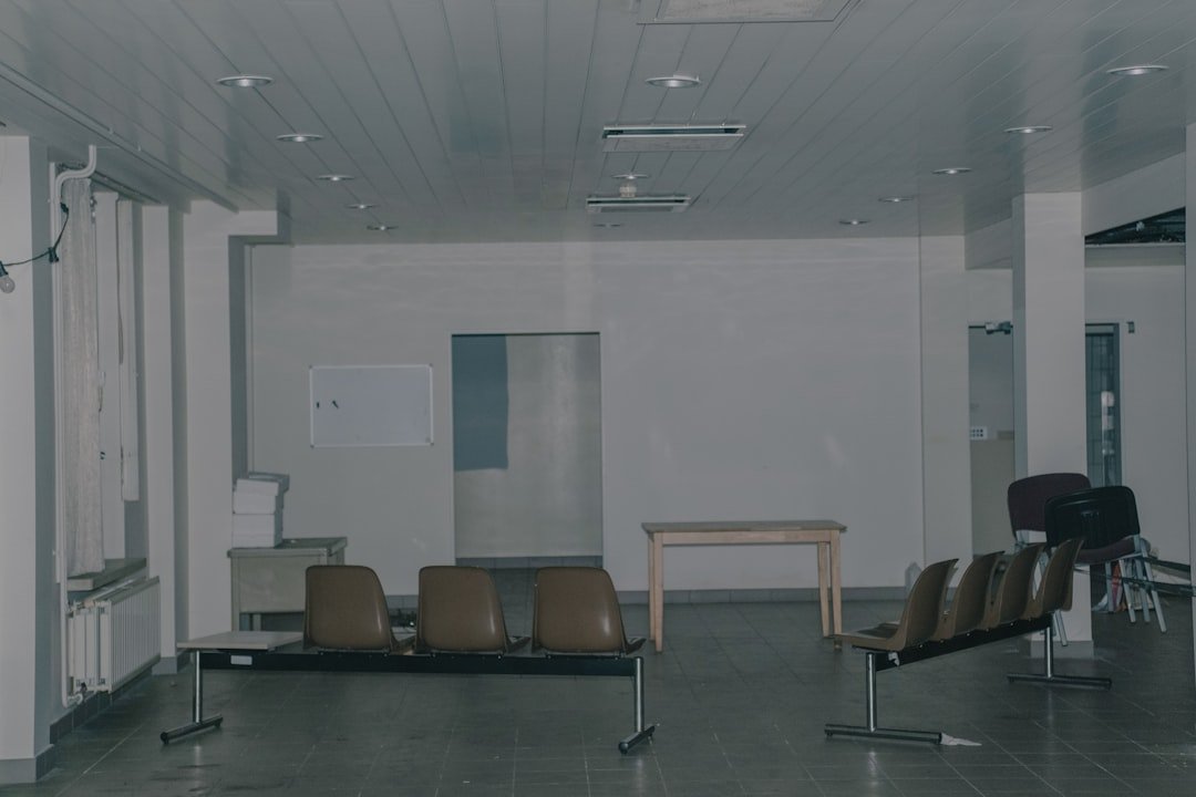 black and brown armchairs near white wall