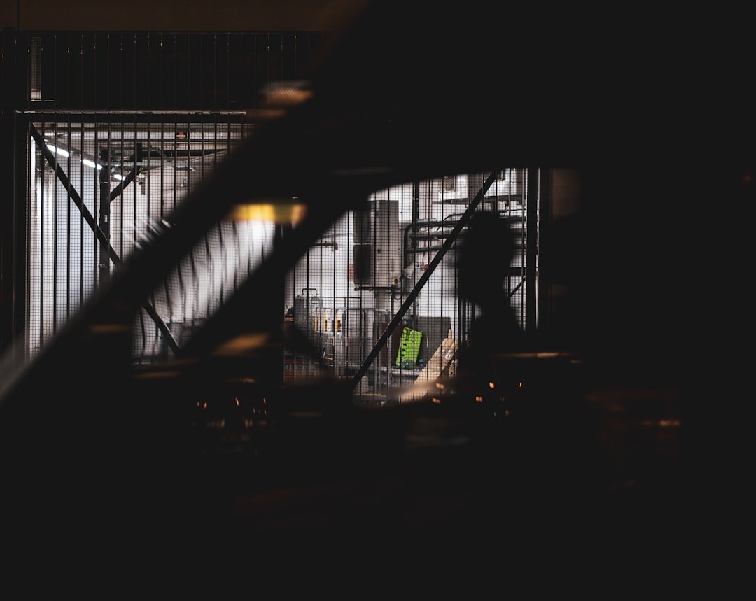 silhouette of person walking on the bridge during night time