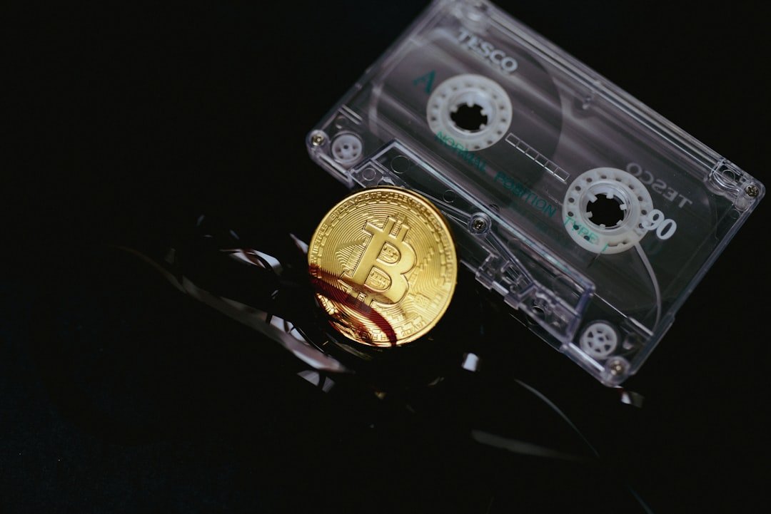 a bitcoin is sitting on top of a pair of scissors