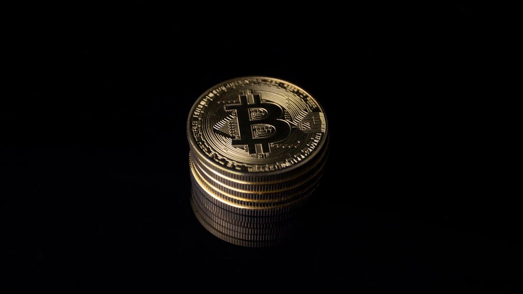 a stack of gold bitcoins on a black background