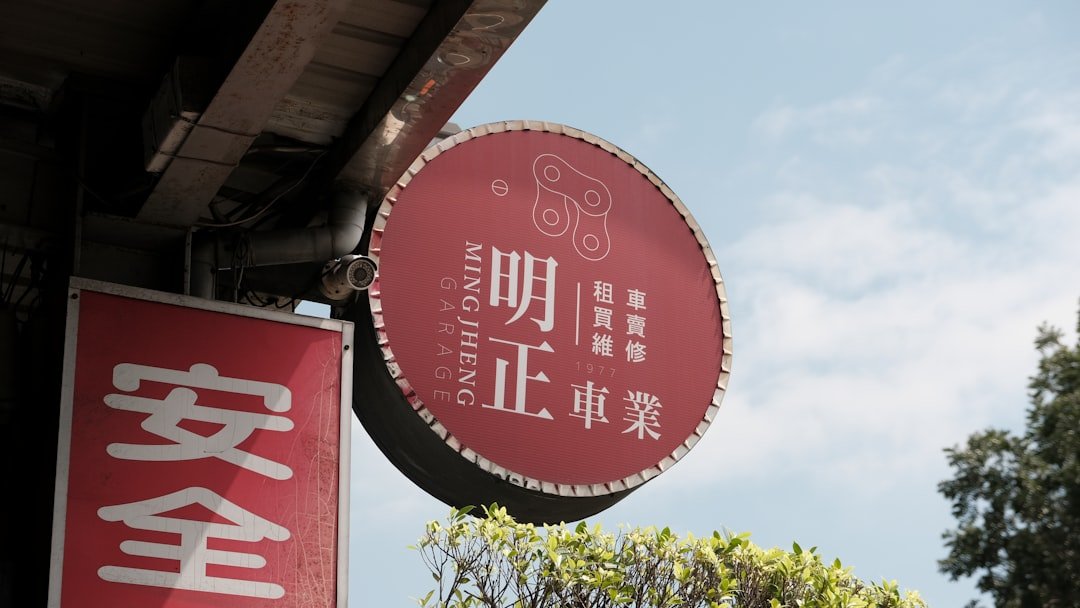 a red sign hanging from the side of a building