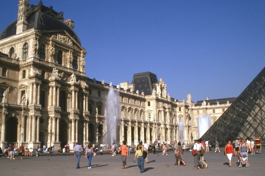 A group of people standing in front of a large building