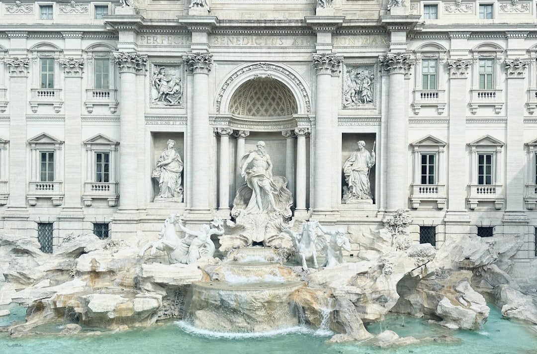 a large white building with a fountain in front of it