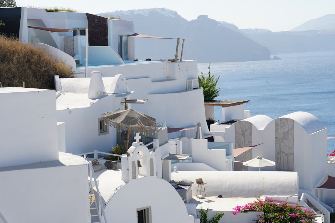 A row of white buildings next to a body of water