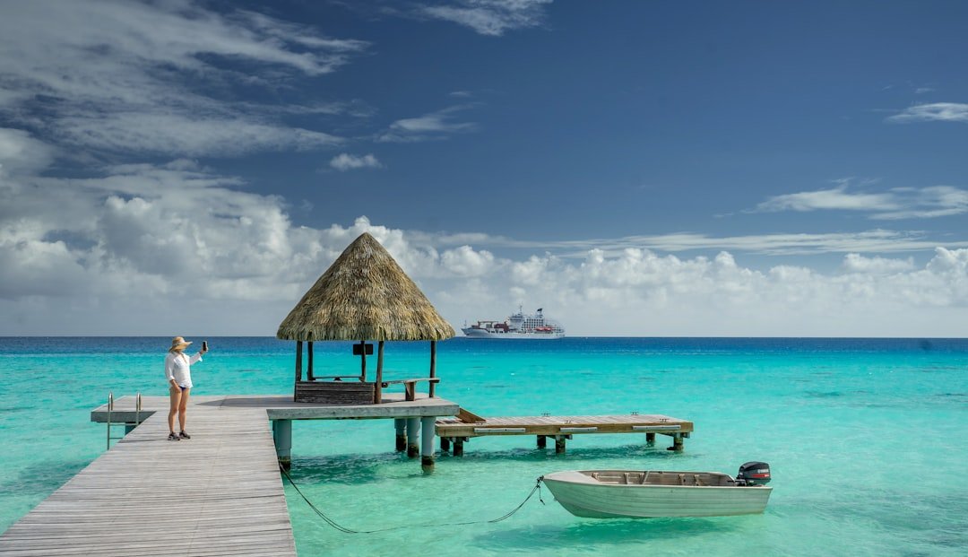 a woman standing on a dock next to a boat